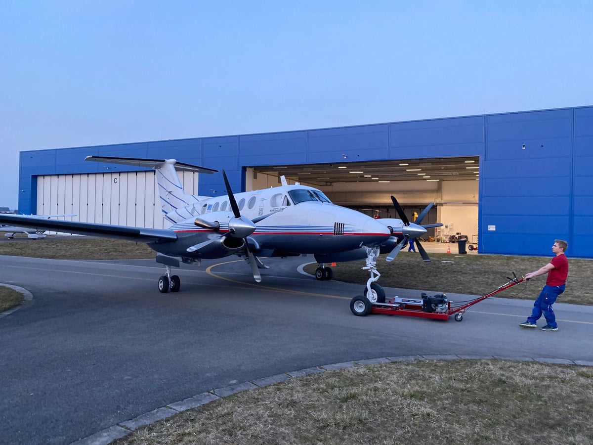 Twin-engine aircraft at a hangar
